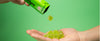 Close-up of hand presenting THC gummies from Drops Candies.