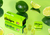 Several green, edible THC gummies displayed with their green container and limes, all with a vibrant green color.